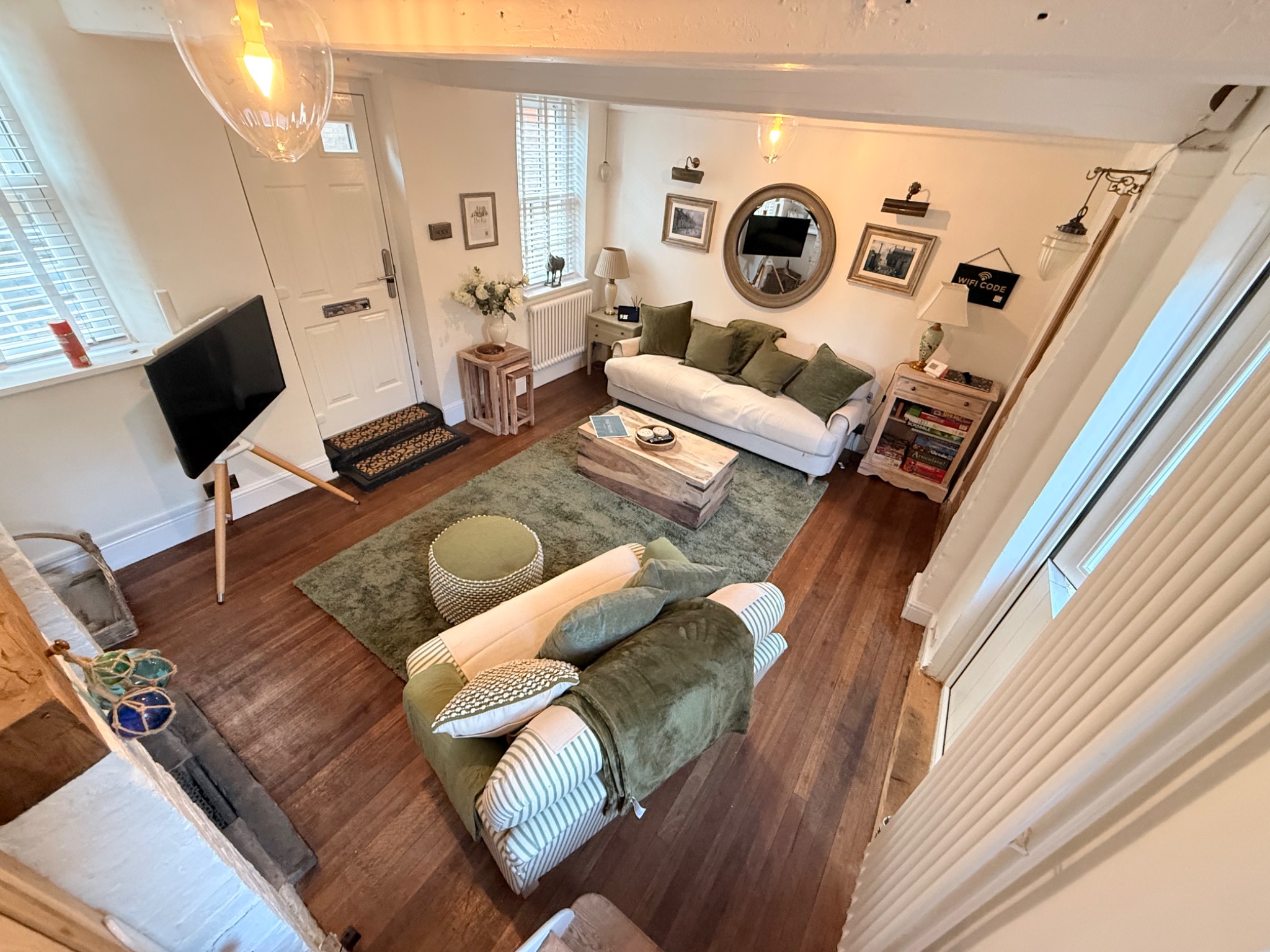 The Nook living room with comfortable seating and timber floor